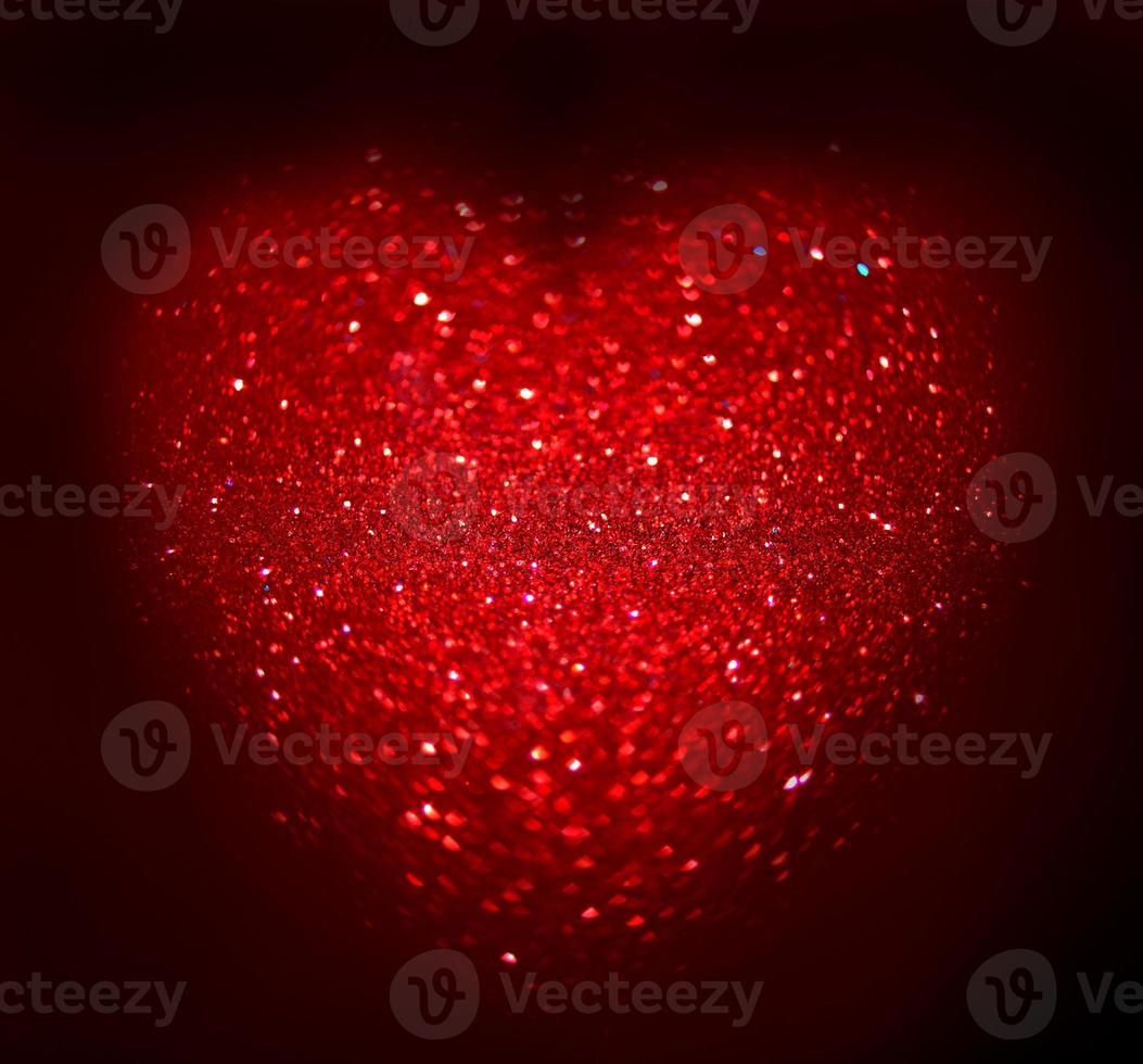 Red Blur heart shape of ligth bokeh on a black background photo