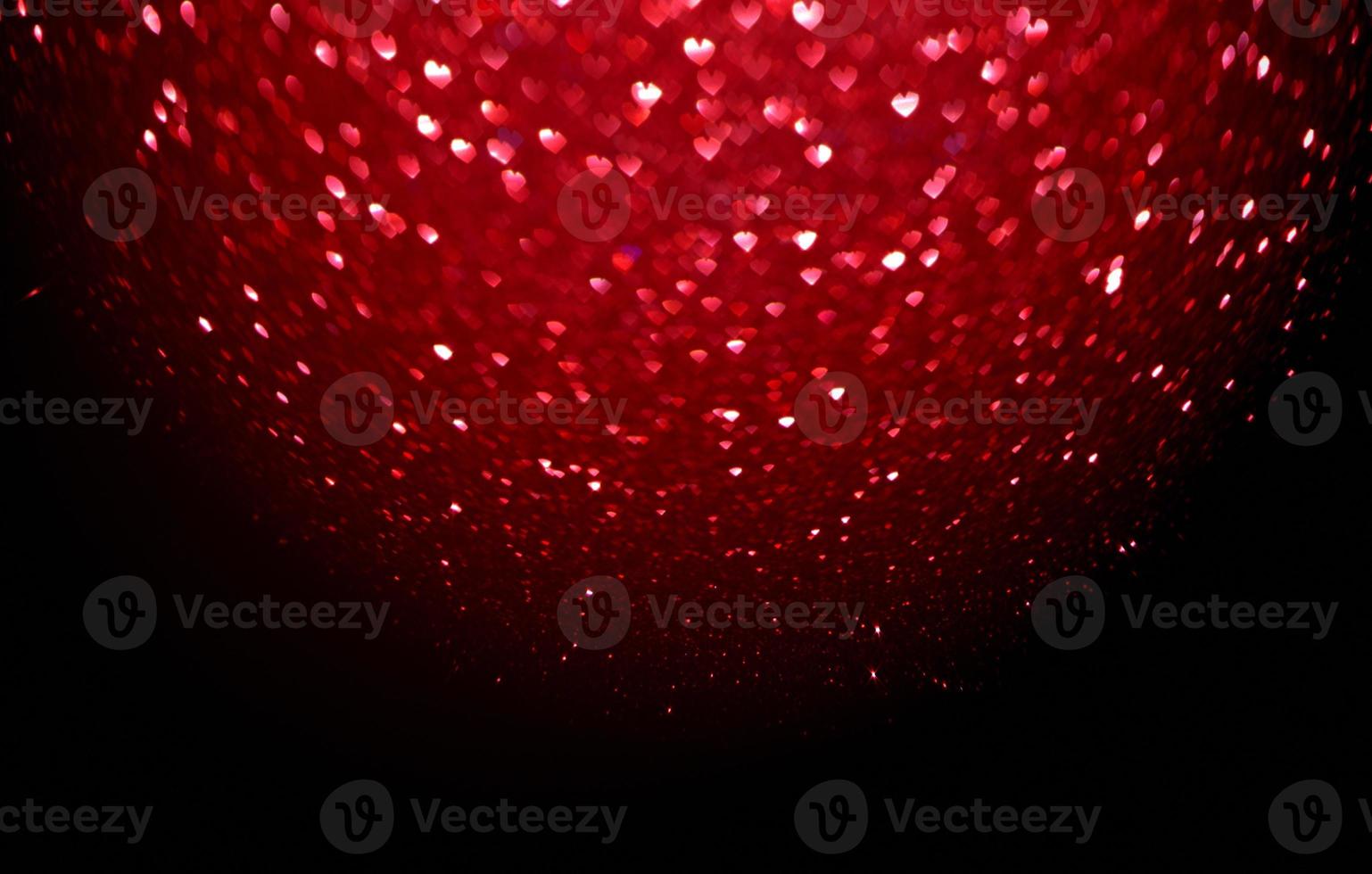 Red Blur heart shape of ligth bokeh on a black background photo