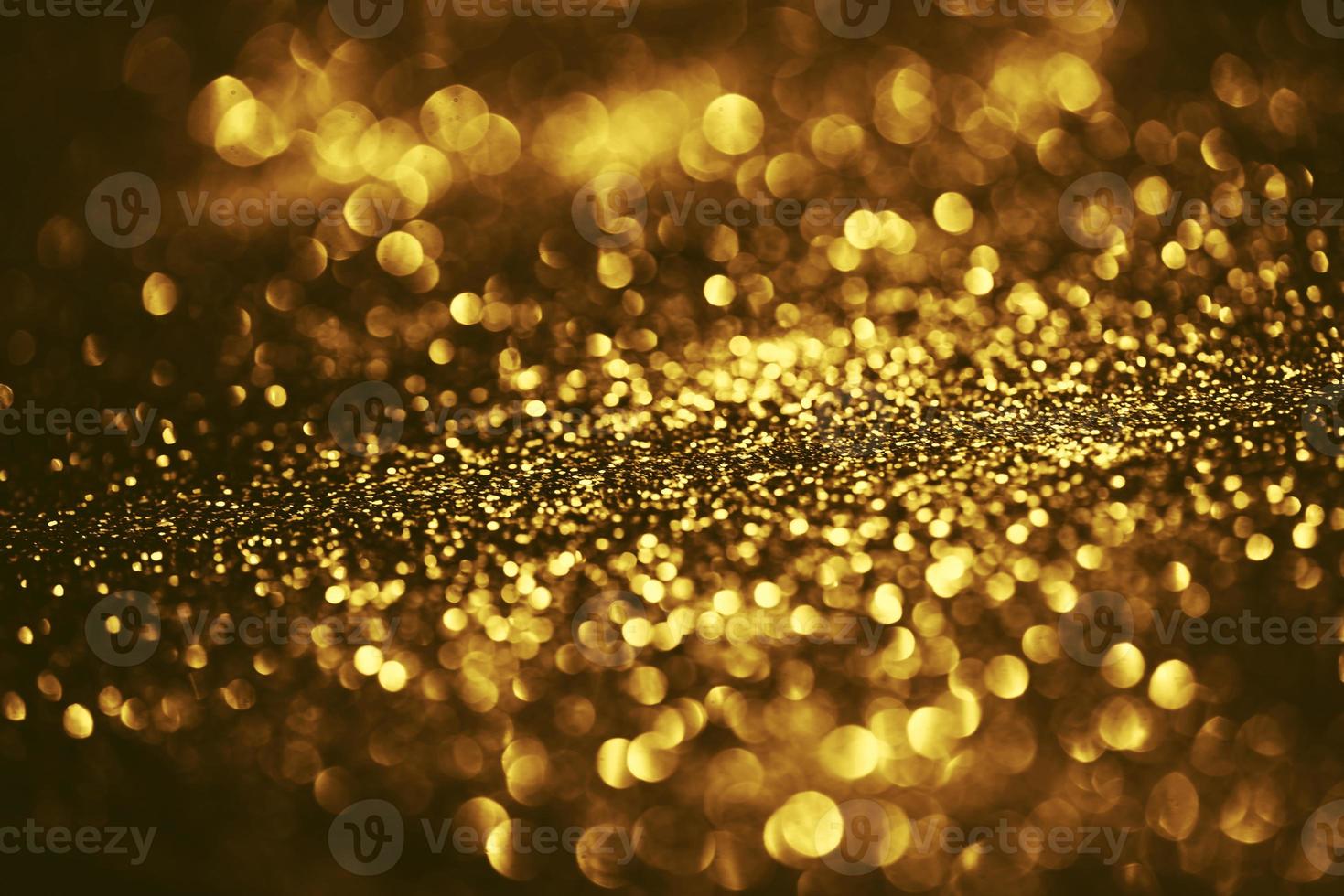 Golden glitter bokeh lighting texture Blurred abstract background for birthday, anniversary, wedding, new year eve or Christmas photo