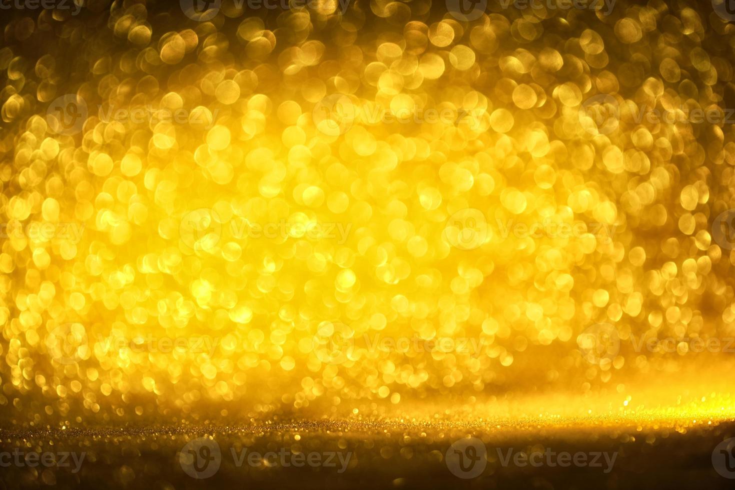 Golden glitter bokeh lighting texture Blurred abstract background for birthday, anniversary, wedding, new year eve or Christmas photo