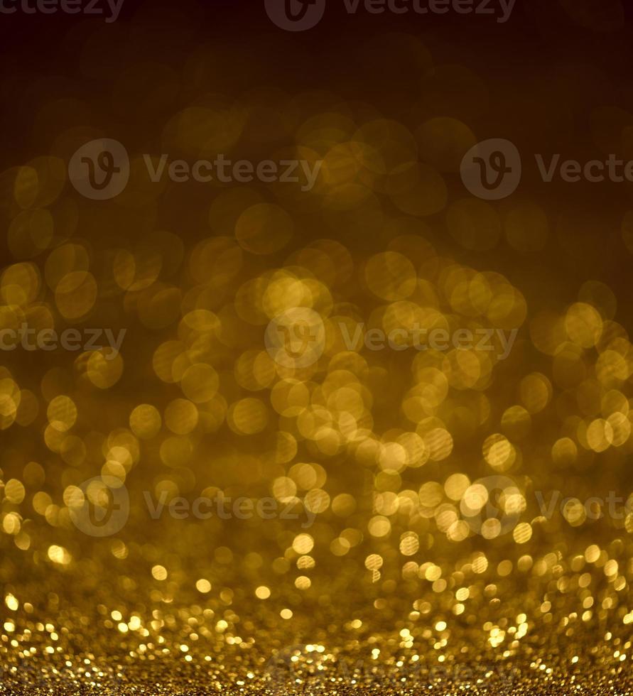 Golden glitter bokeh lighting texture Blurred abstract background for birthday, anniversary, wedding, new year eve or Christmas photo