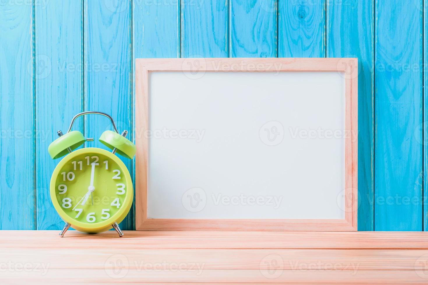 clock and white board on wood floor background Education concept photo