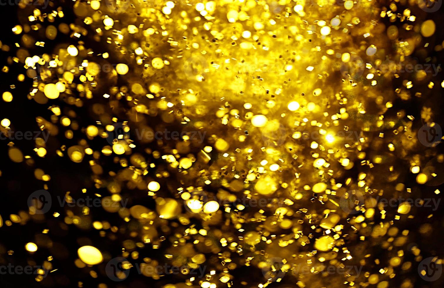 Golden glitter bokeh lighting texture Blurred abstract background for birthday, anniversary, wedding, new year eve or Christmas photo