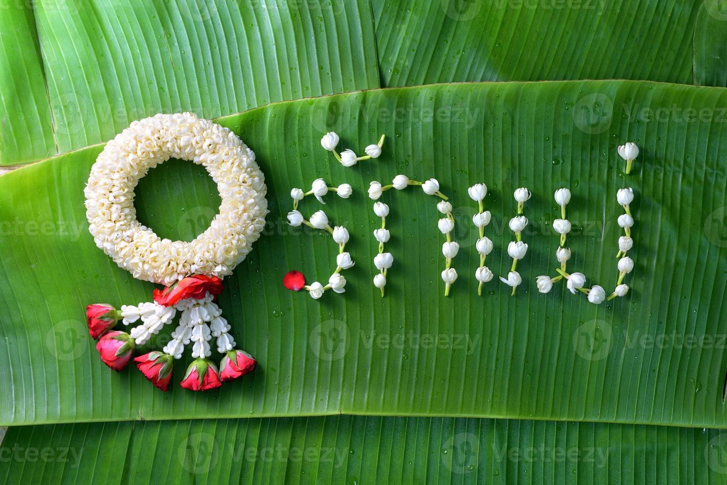 Thai traditional jasmine garland. symbol of Mother's day in thailand on Banana leaf with Love Mother in Thai word. photo