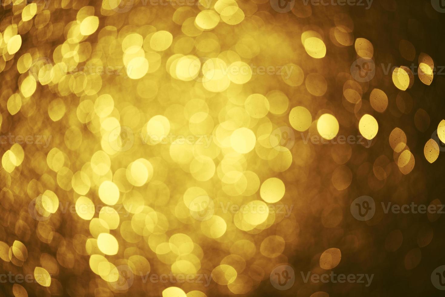 Golden glitter bokeh lighting texture Blurred abstract background for birthday, anniversary, wedding, new year eve or Christmas photo