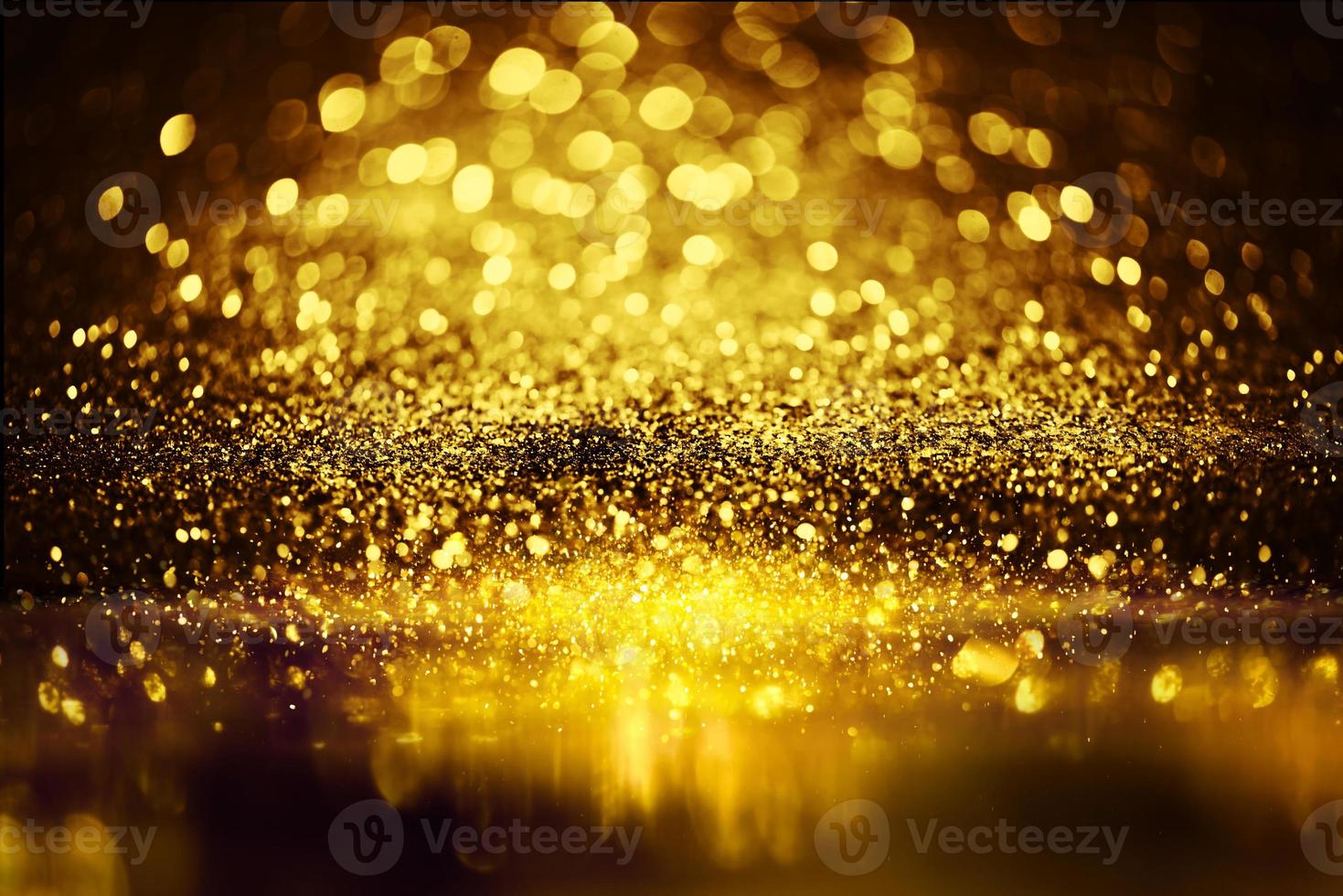 Golden glitter spatter are bokeh lighting texture blurred abstract background for anniversary celebration photo