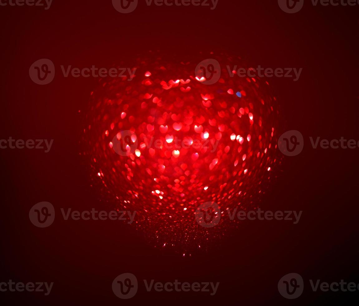 Red Blur heart shape of ligth bokeh on a black background photo