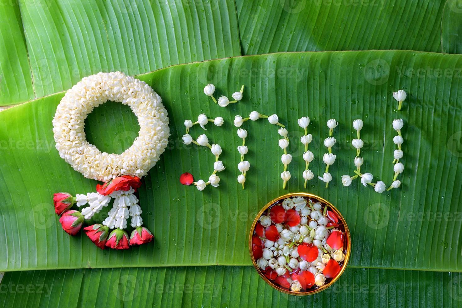 Thai traditional jasmine garland. symbol of Mother's day in thailand on Banana leaf with Love Mother in Thai word. photo