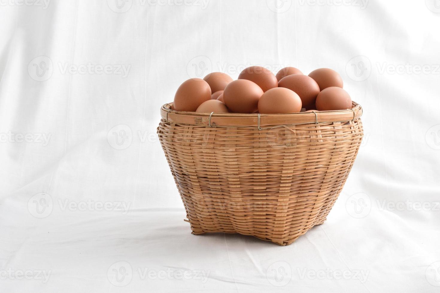 eggs in basket filled isolated on white background photo