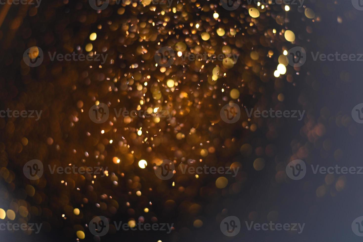 Golden glitter bokeh lighting texture Blurred abstract background for birthday, anniversary, wedding, new year eve or Christmas photo