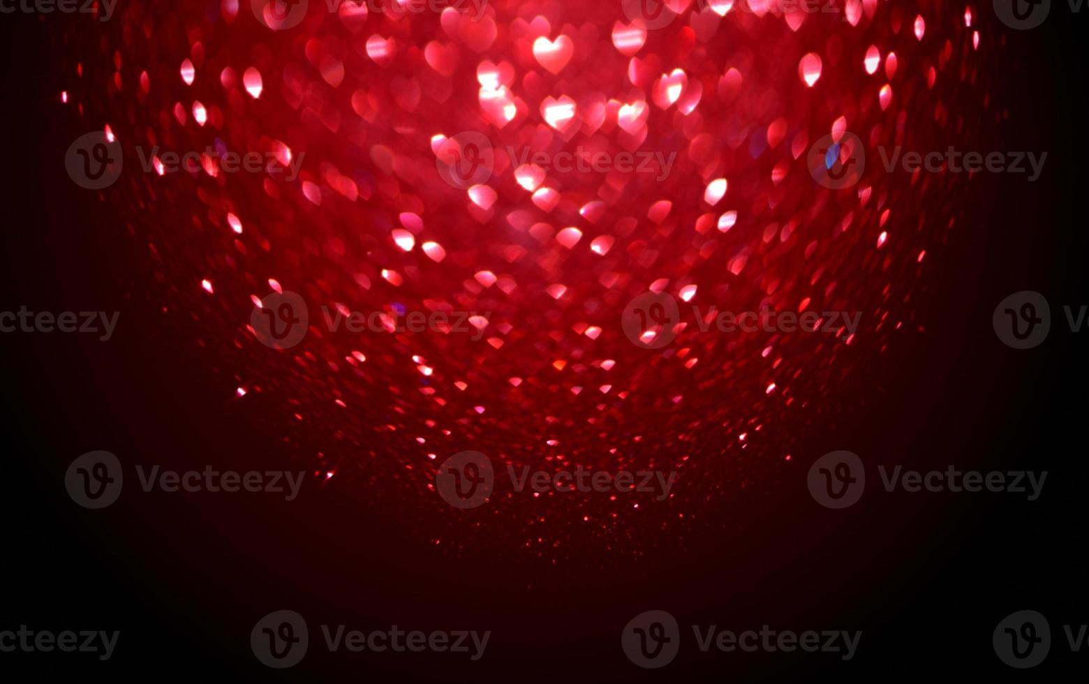 Red Blur heart shape of ligth bokeh on a black background photo