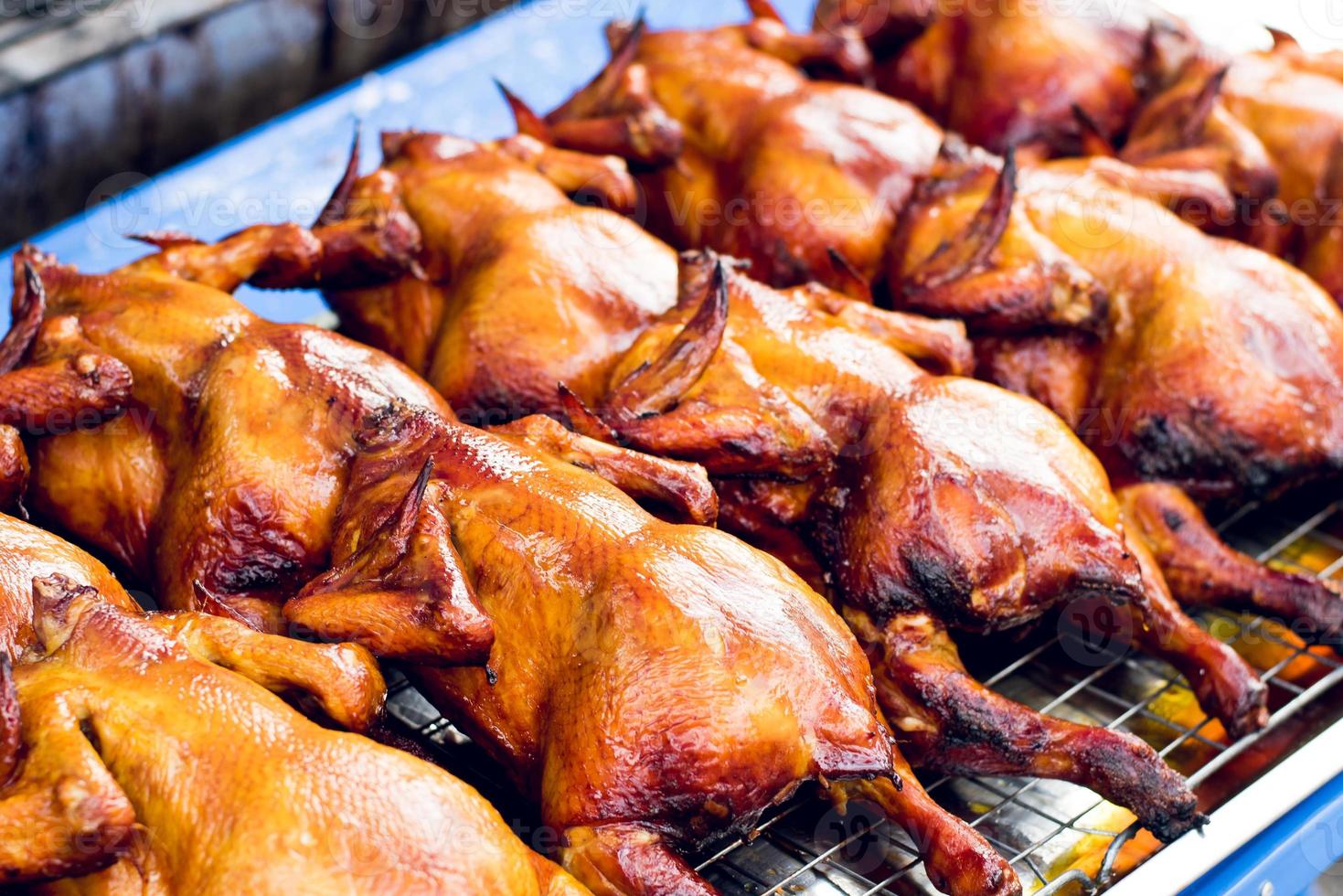 Roasted chicken ready to eat on a steel grill photo