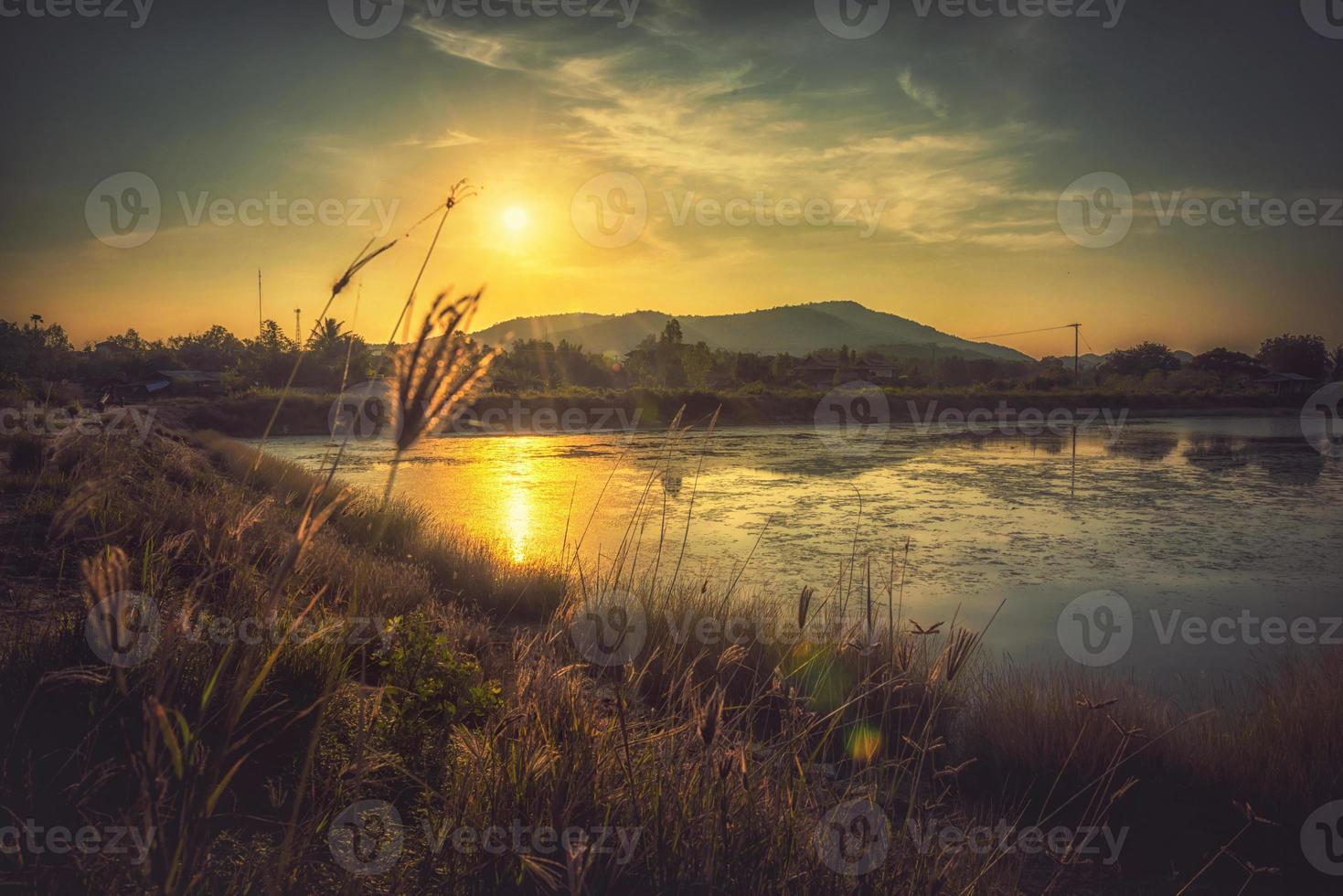 Nature with mountains rivers grass the light of the sunset photo