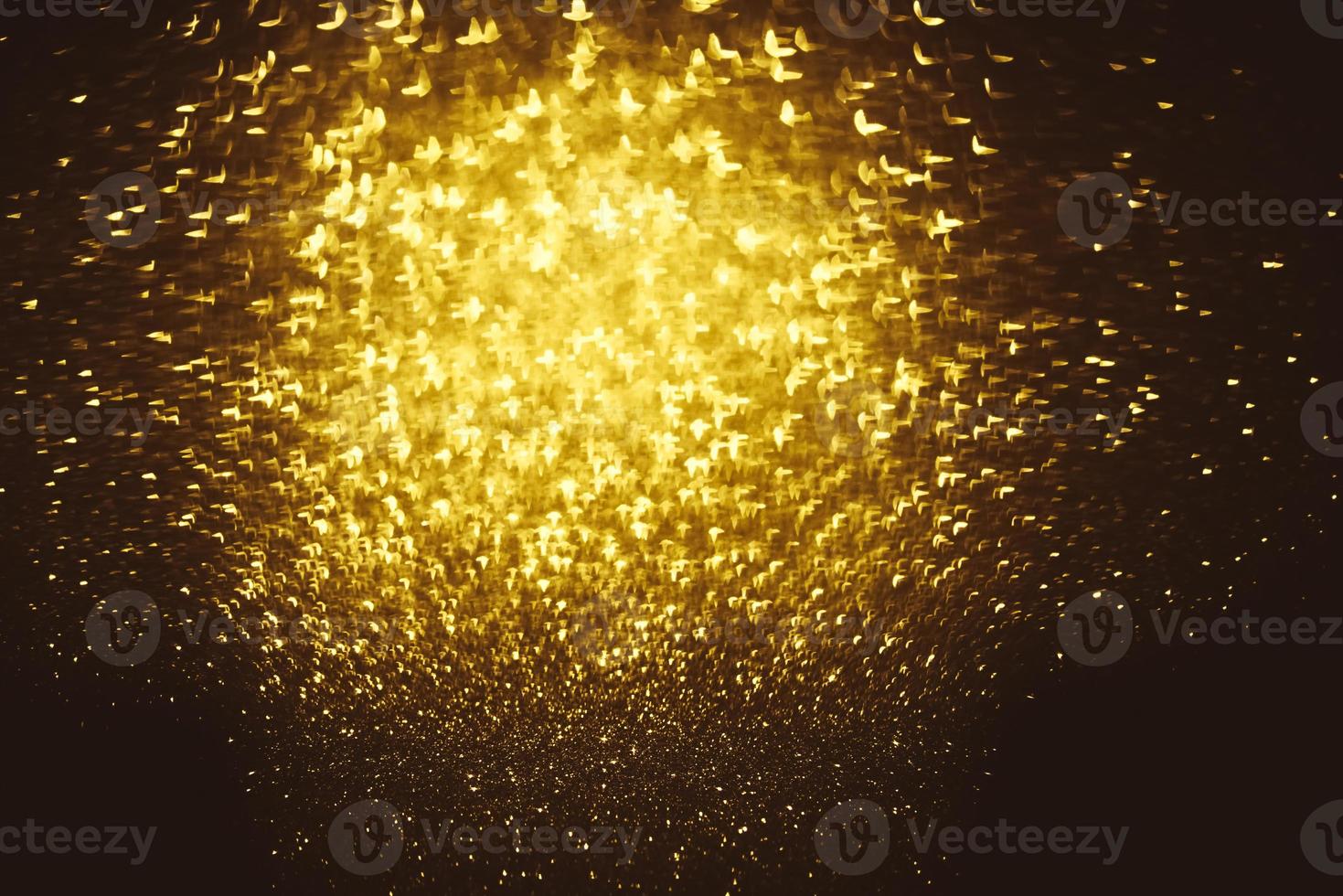Golden glitter bokeh lighting texture Blurred abstract background for birthday, anniversary, wedding, new year eve or Christmas photo