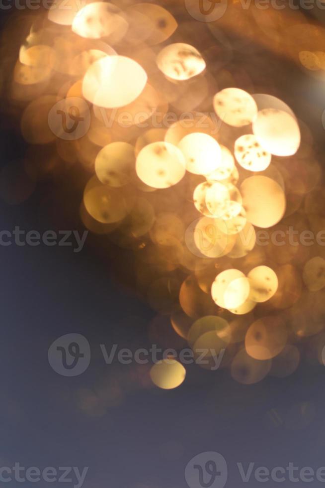 Golden glitter bokeh lighting texture Blurred abstract background for birthday, anniversary, wedding, new year eve or Christmas photo