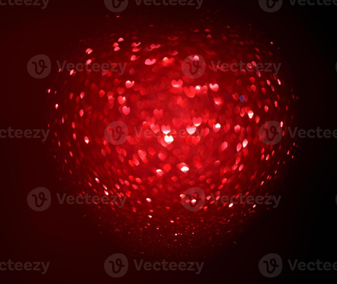 Red Blur heart shape of ligth bokeh on a black background photo