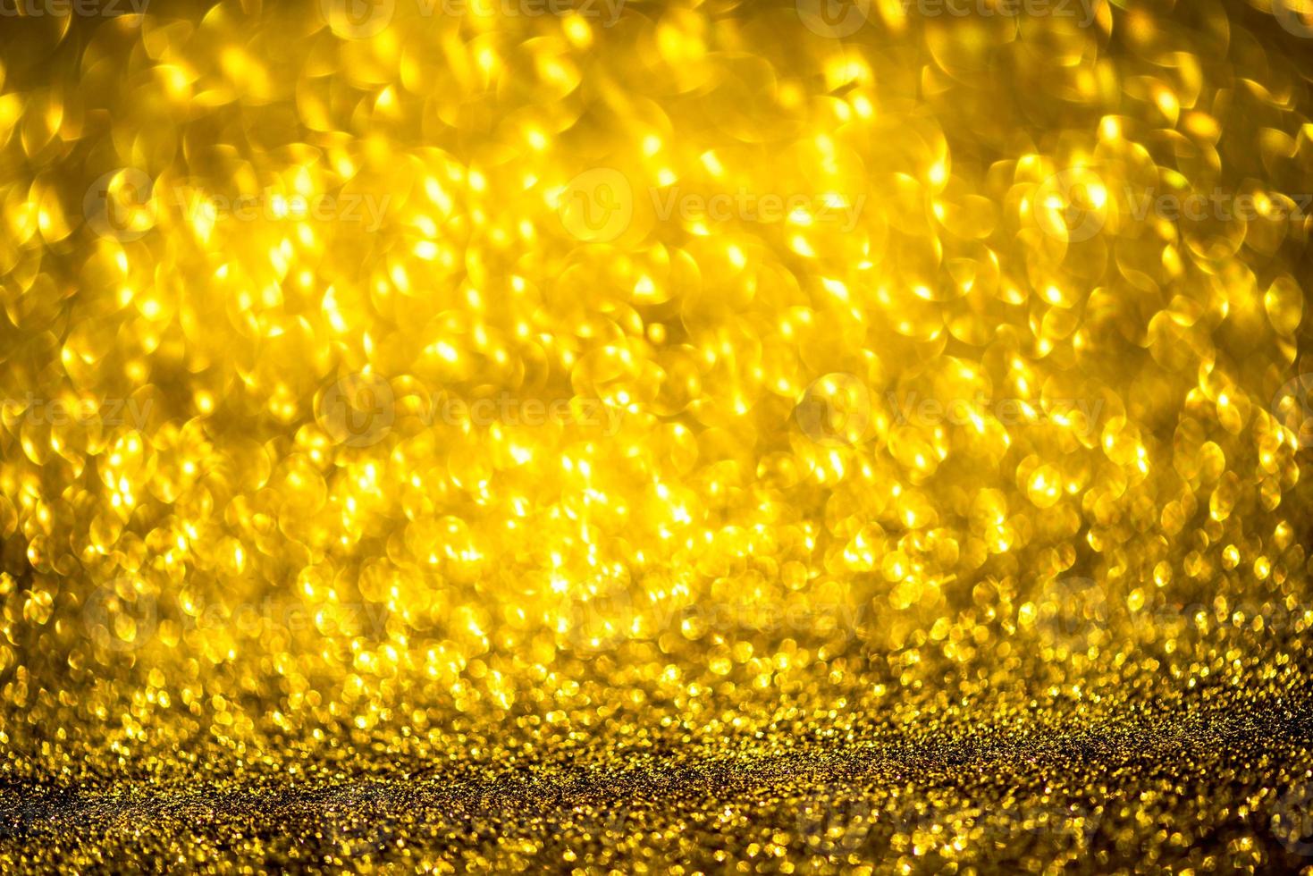 Golden glitter bokeh lighting texture Blurred abstract background for birthday, anniversary, wedding, new year eve or Christmas photo