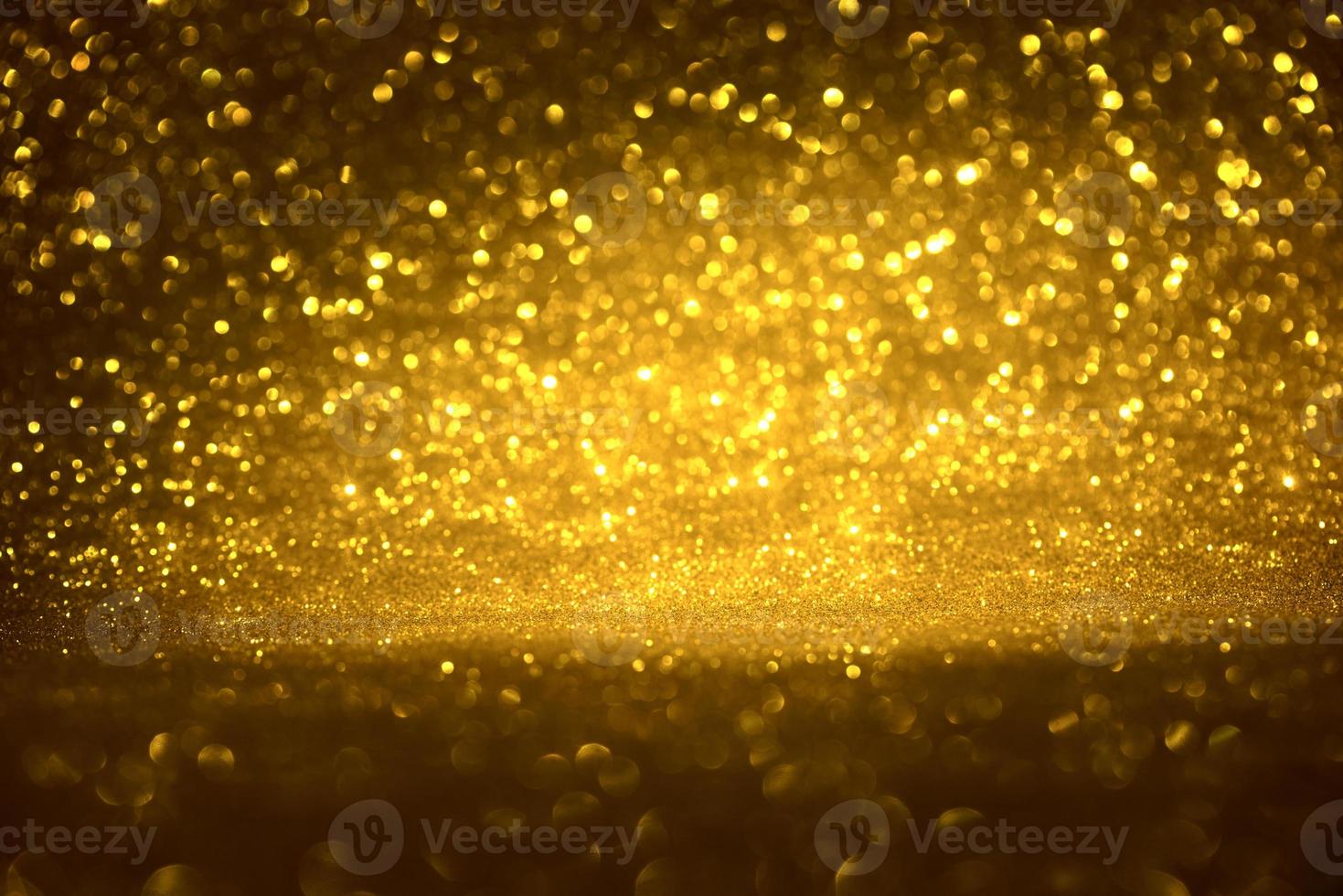 Golden glitter bokeh lighting texture Blurred abstract background for birthday, anniversary, wedding, new year eve or Christmas photo