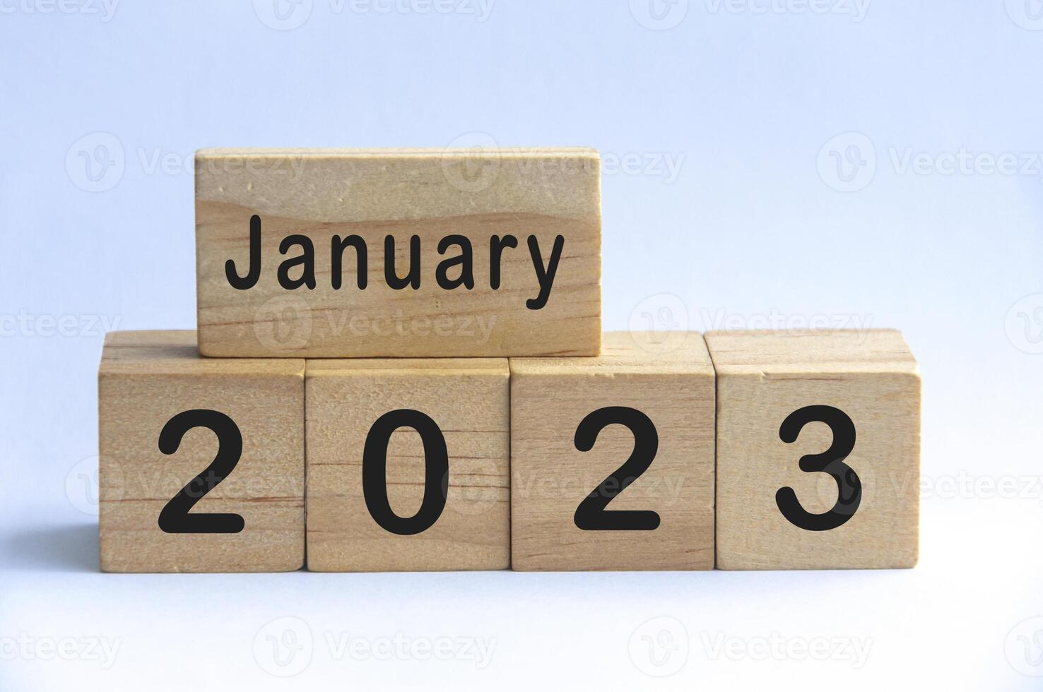 January 2023 text on wooden blocks with white color background. Copy space photo