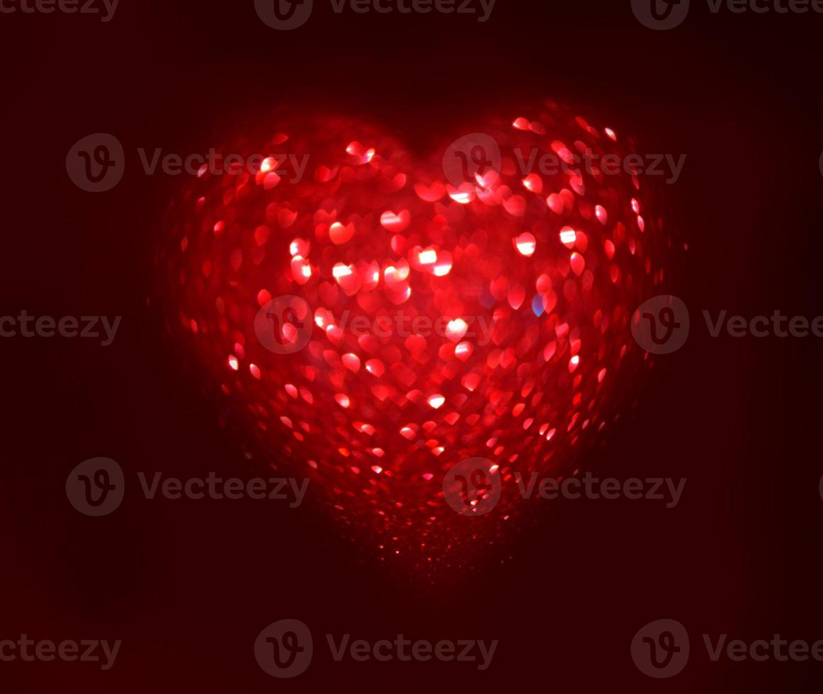 Red Blur heart shape of ligth bokeh on a black background photo