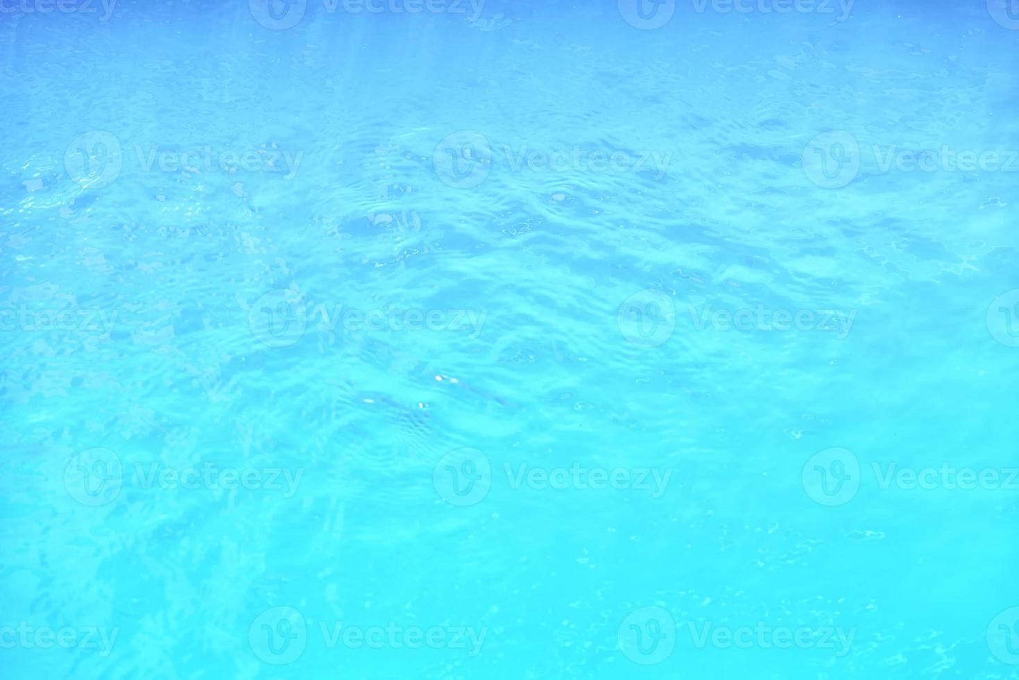 Waving water surface background in the pool. photo