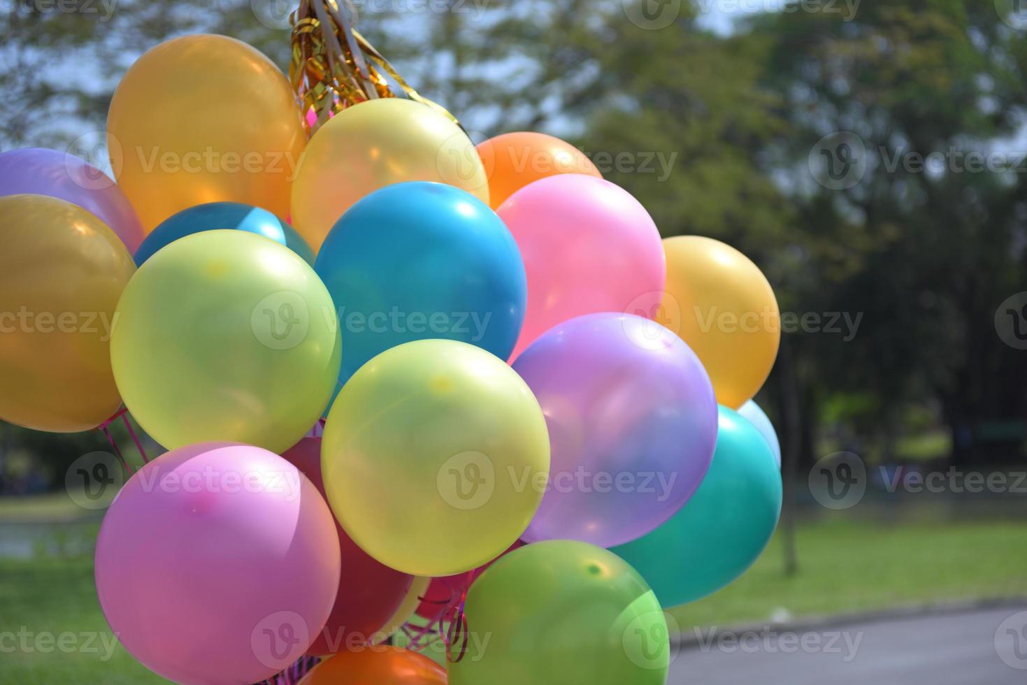 Colorful balloons with celebration and various party confetti photo