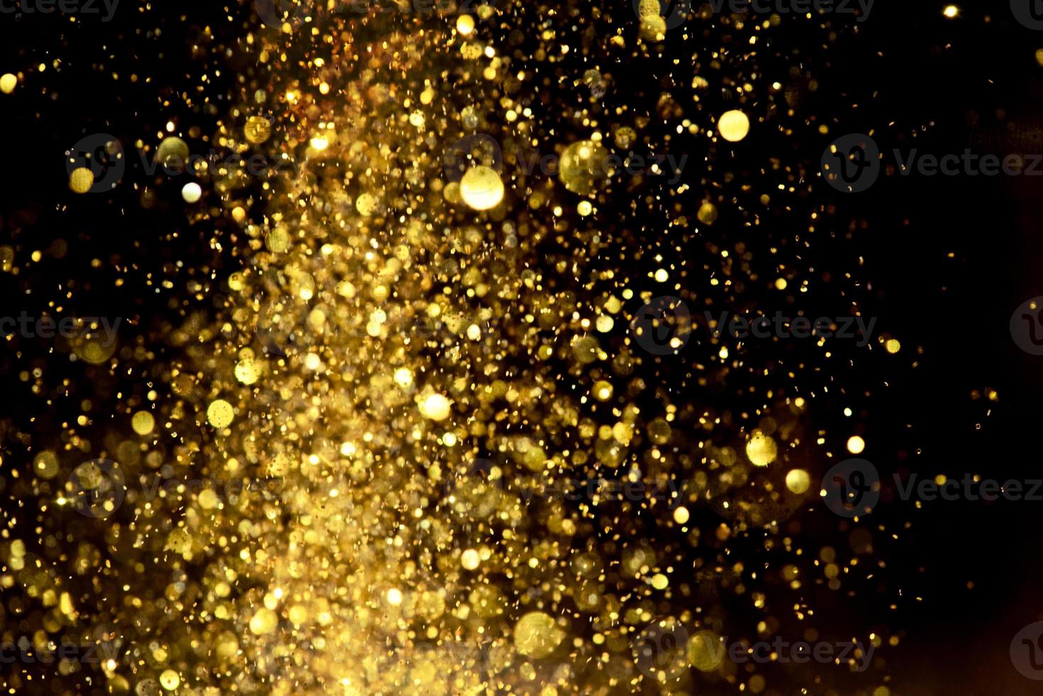 Golden glitter bokeh lighting texture Blurred abstract background for birthday, anniversary, wedding, new year eve or Christmas photo