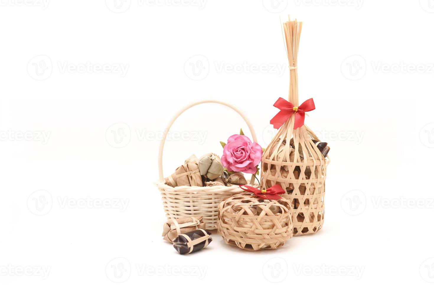 Thai traditional dessert in wicker bamboo basket On white background photo