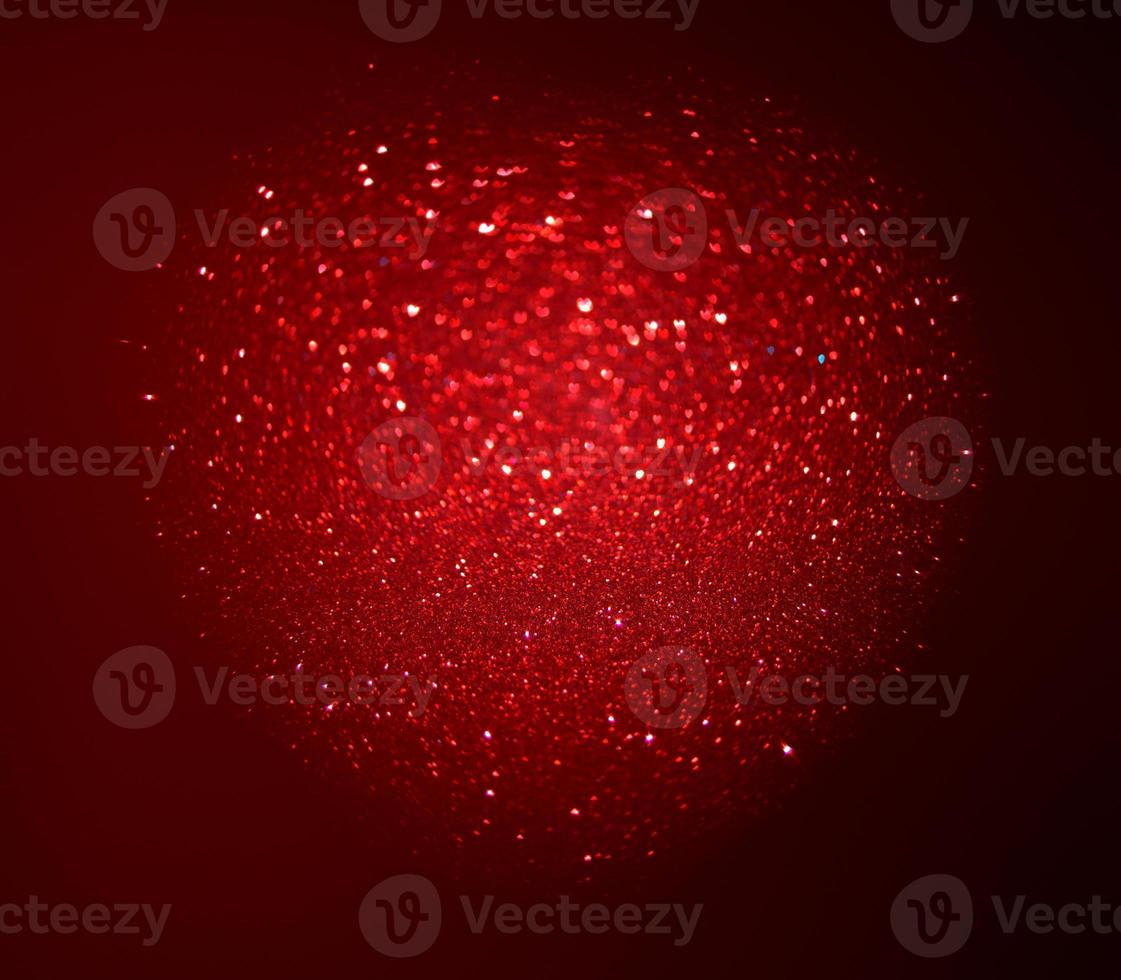 Red Blur heart shape of ligth bokeh on a black background photo