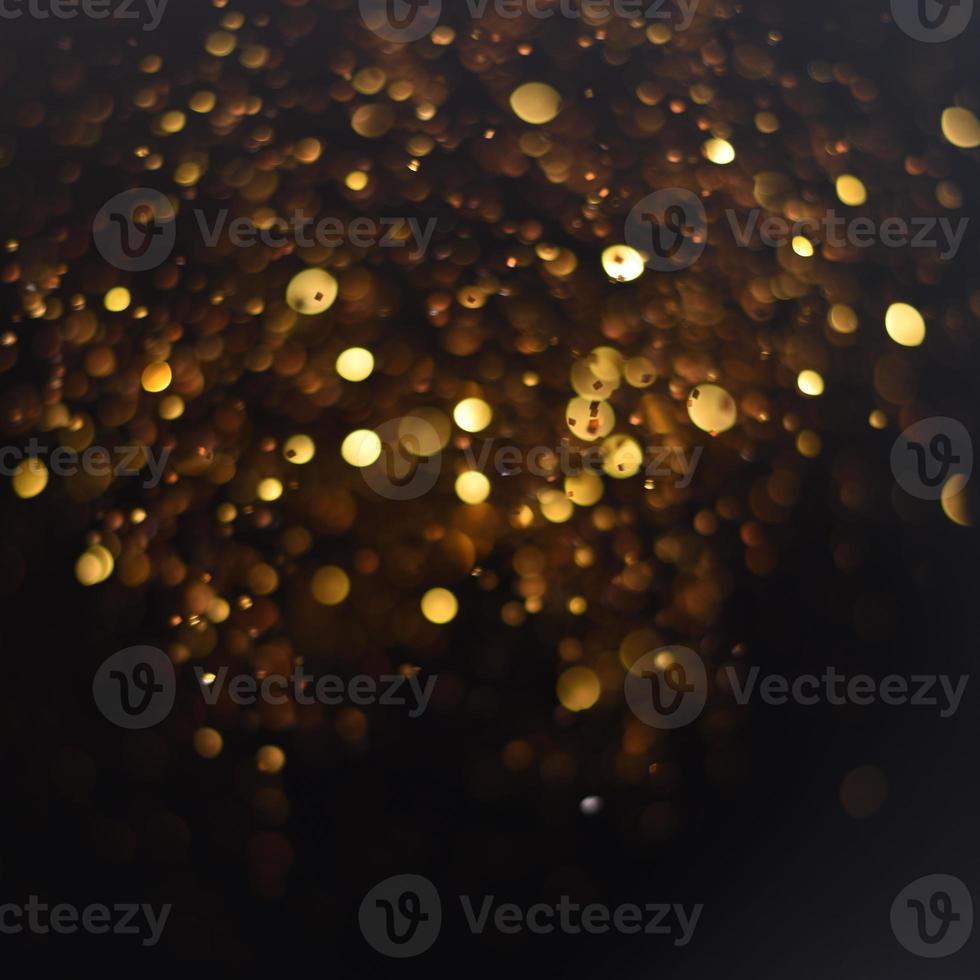 Golden glitter bokeh lighting texture Blurred abstract background for birthday, anniversary, wedding, new year eve or Christmas photo