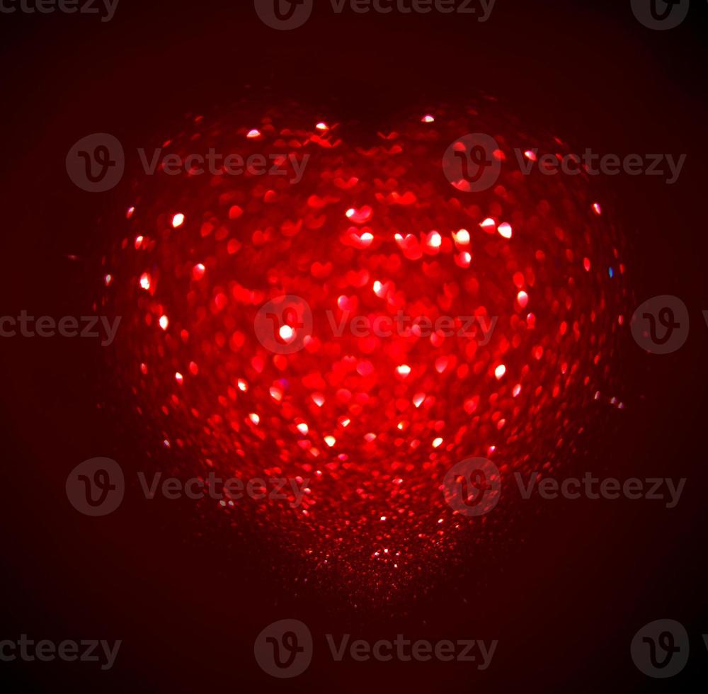 Red Blur heart shape of ligth bokeh on a black background photo