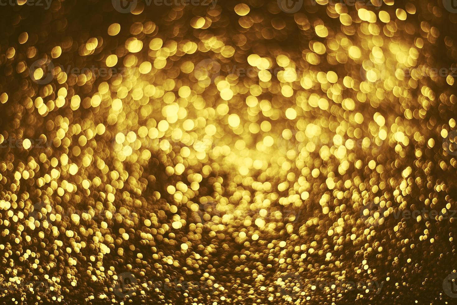 Golden glitter bokeh lighting texture Blurred abstract background for birthday, anniversary, wedding, new year eve or Christmas photo