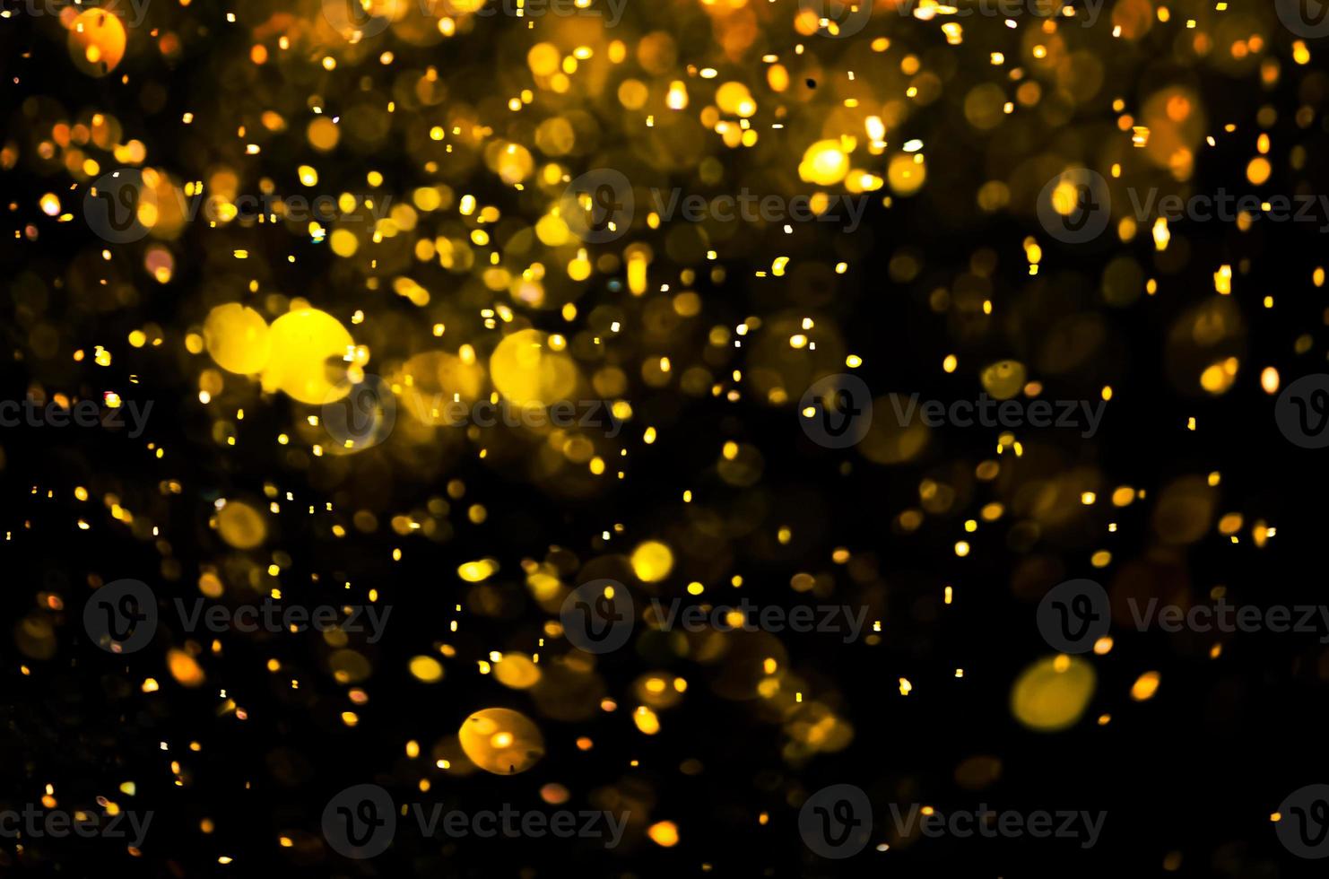 Golden glitter bokeh lighting texture Blurred abstract background for birthday, anniversary, wedding, new year eve or Christmas photo