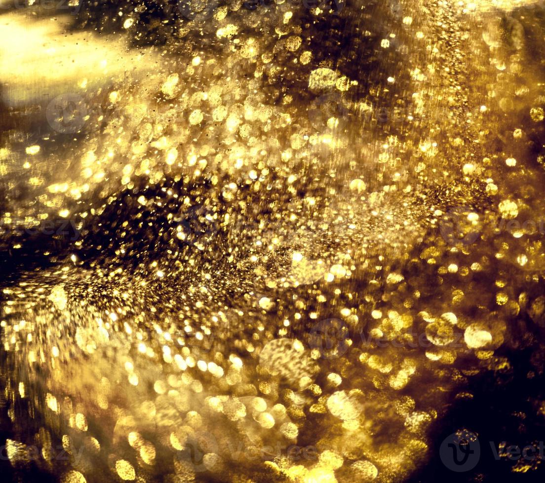 Golden glitter bokeh lighting texture Blurred abstract background for birthday, anniversary, wedding, new year eve or Christmas photo