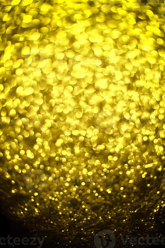 Golden glitter bokeh lighting texture Blurred abstract background for birthday, anniversary, wedding, new year eve or Christmas photo