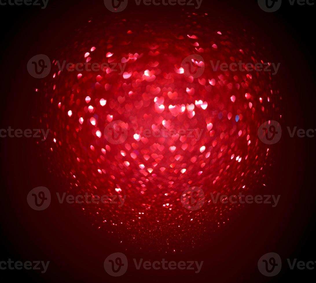 Red Blur heart shape of ligth bokeh on a black background photo