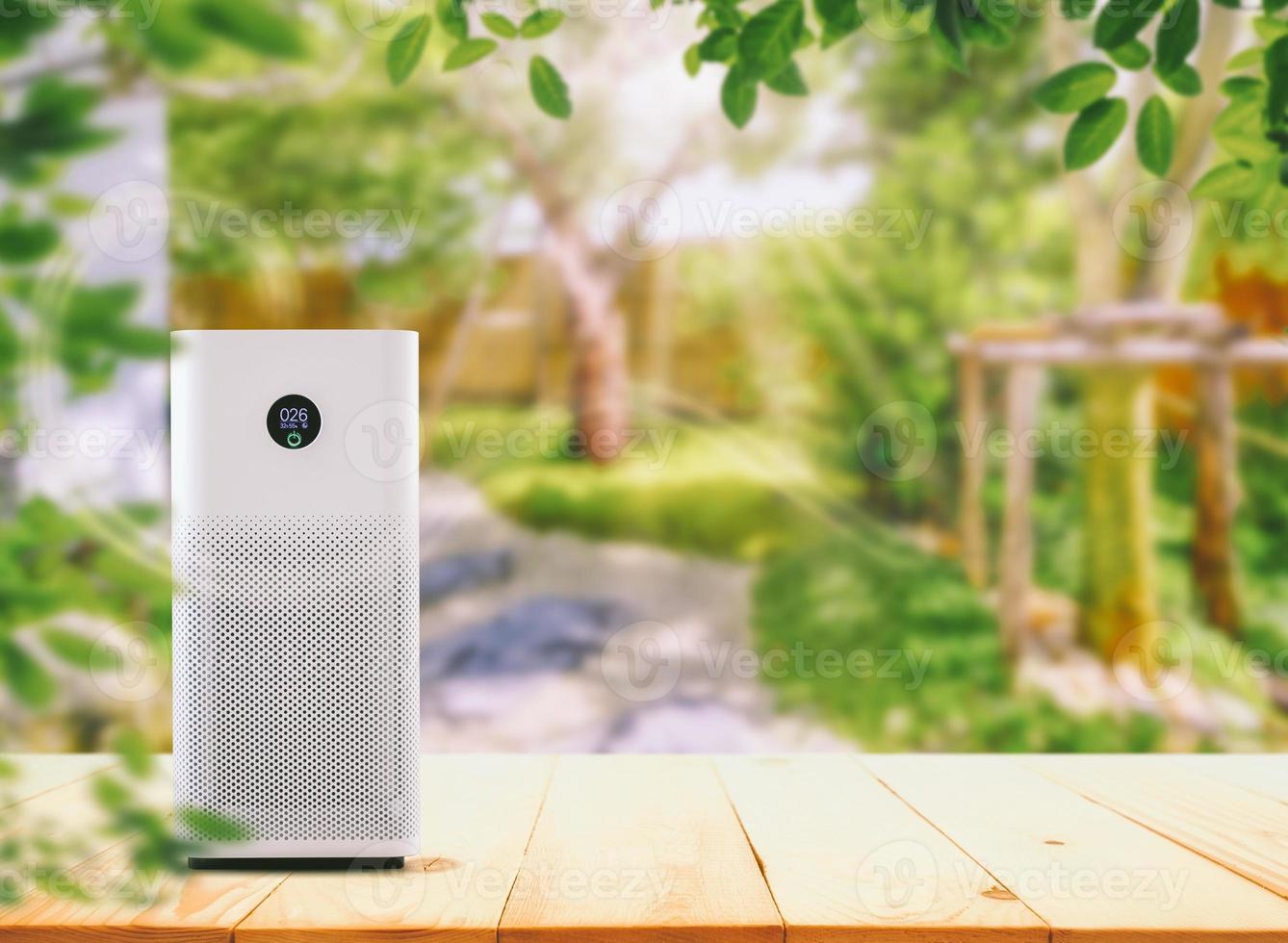 Air Purifier on the wood table at graden.  Air purification from viruses and bacteria photo