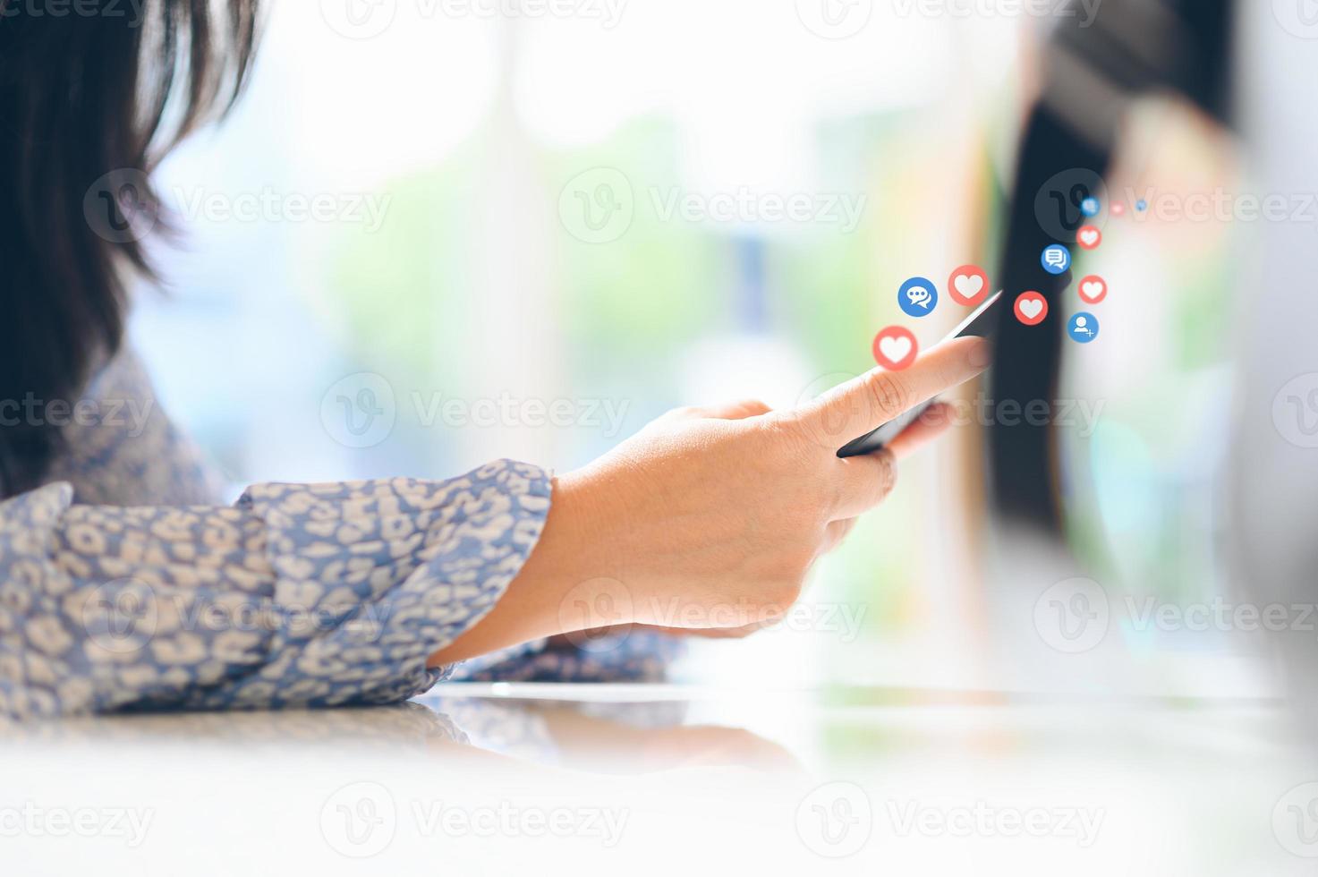 Hand using smart phone with Social media concept photo