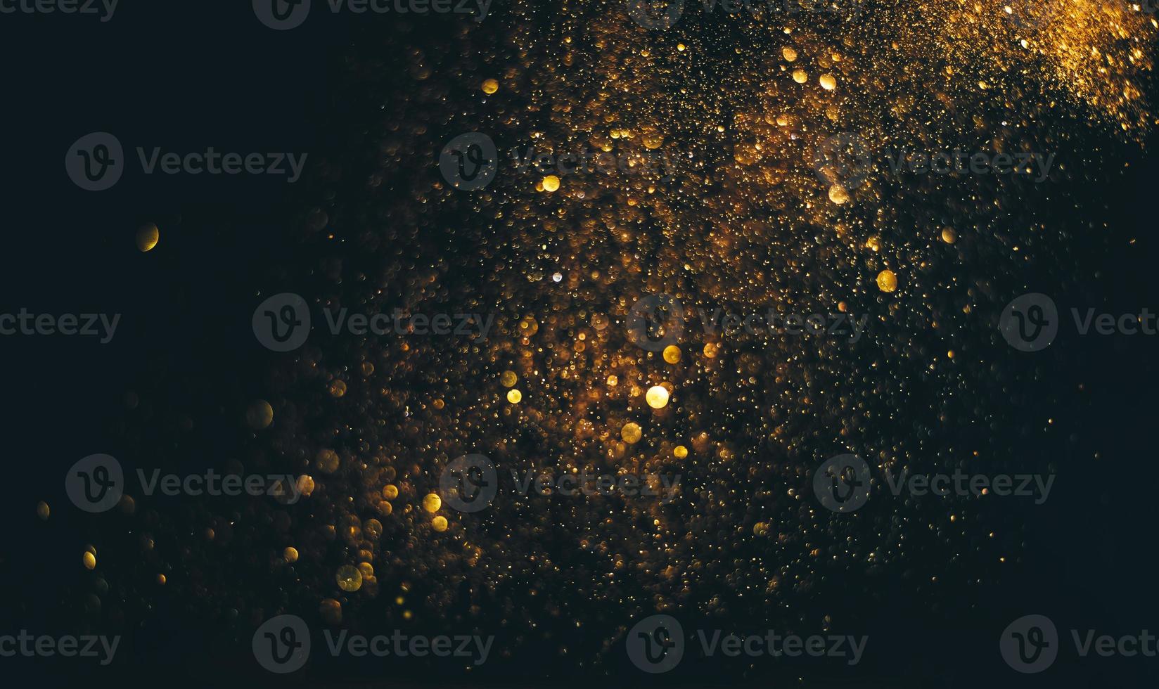 glitter vintage lights background. gold and black. de focused photo