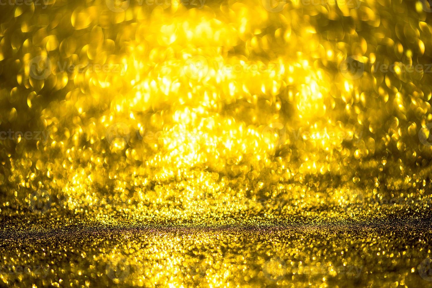 Golden glitter bokeh lighting texture Blurred abstract background for birthday, anniversary, wedding, new year eve or Christmas photo