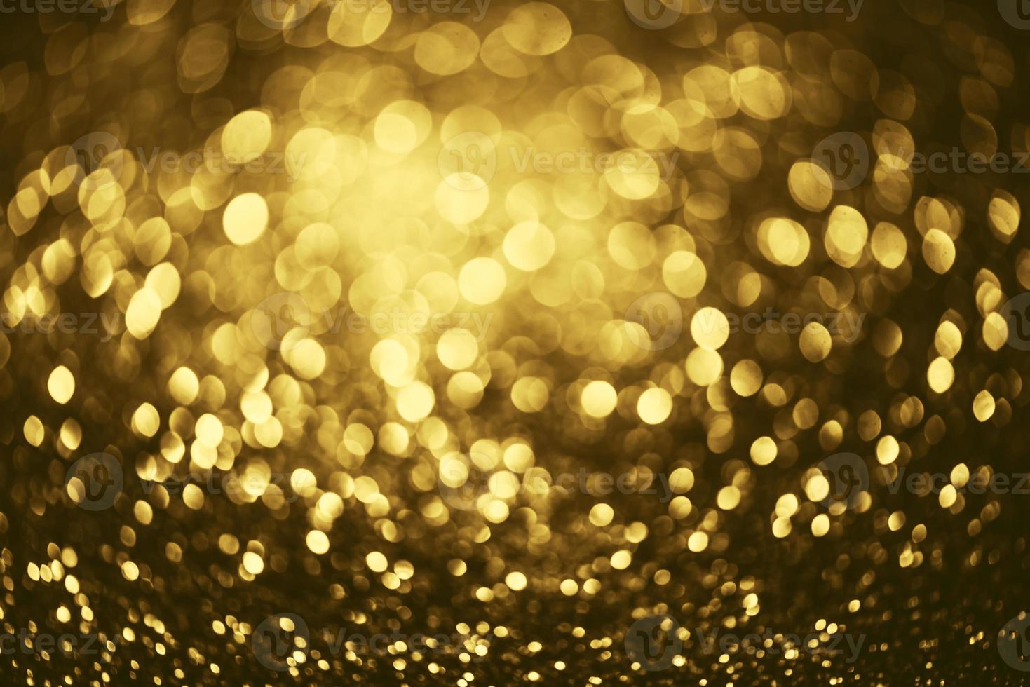 Golden glitter bokeh lighting texture Blurred abstract background for birthday, anniversary, wedding, new year eve or Christmas photo