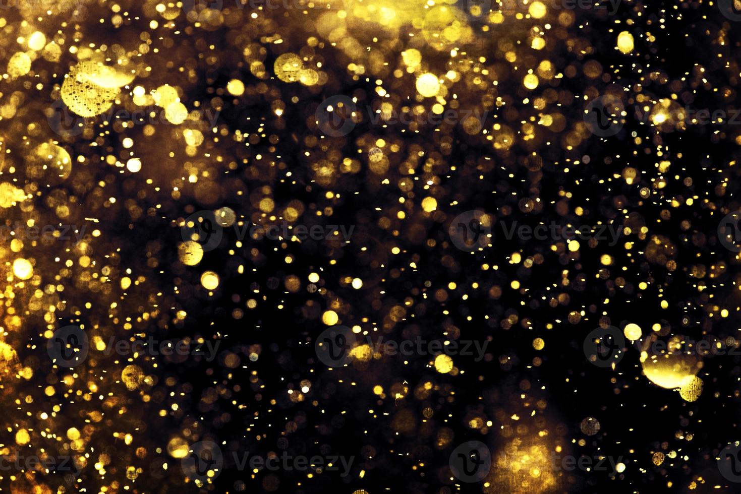 Golden glitter bokeh lighting texture Blurred abstract background for birthday, anniversary, wedding, new year eve or Christmas photo