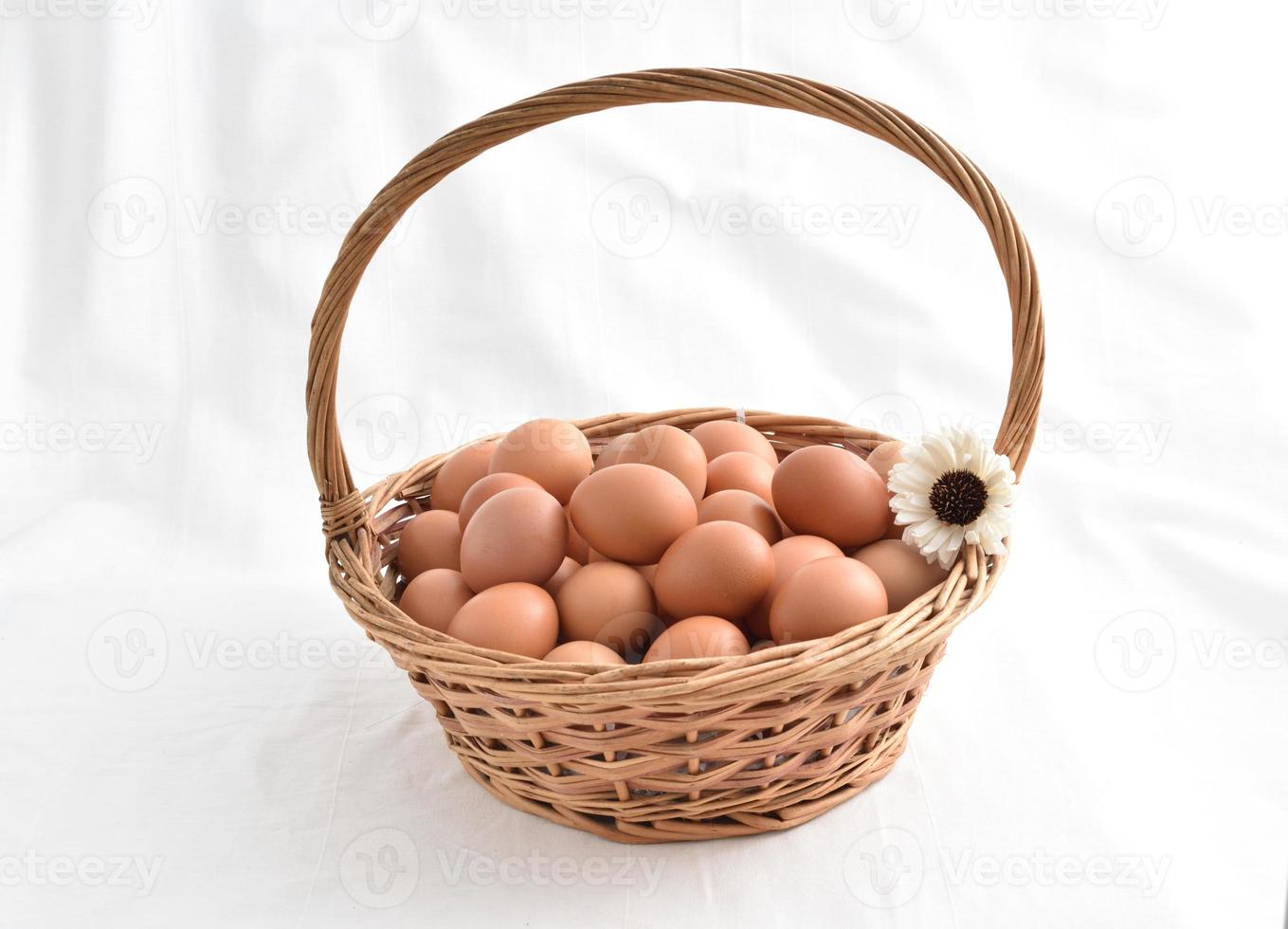 eggs in basket filled isolated on white background photo