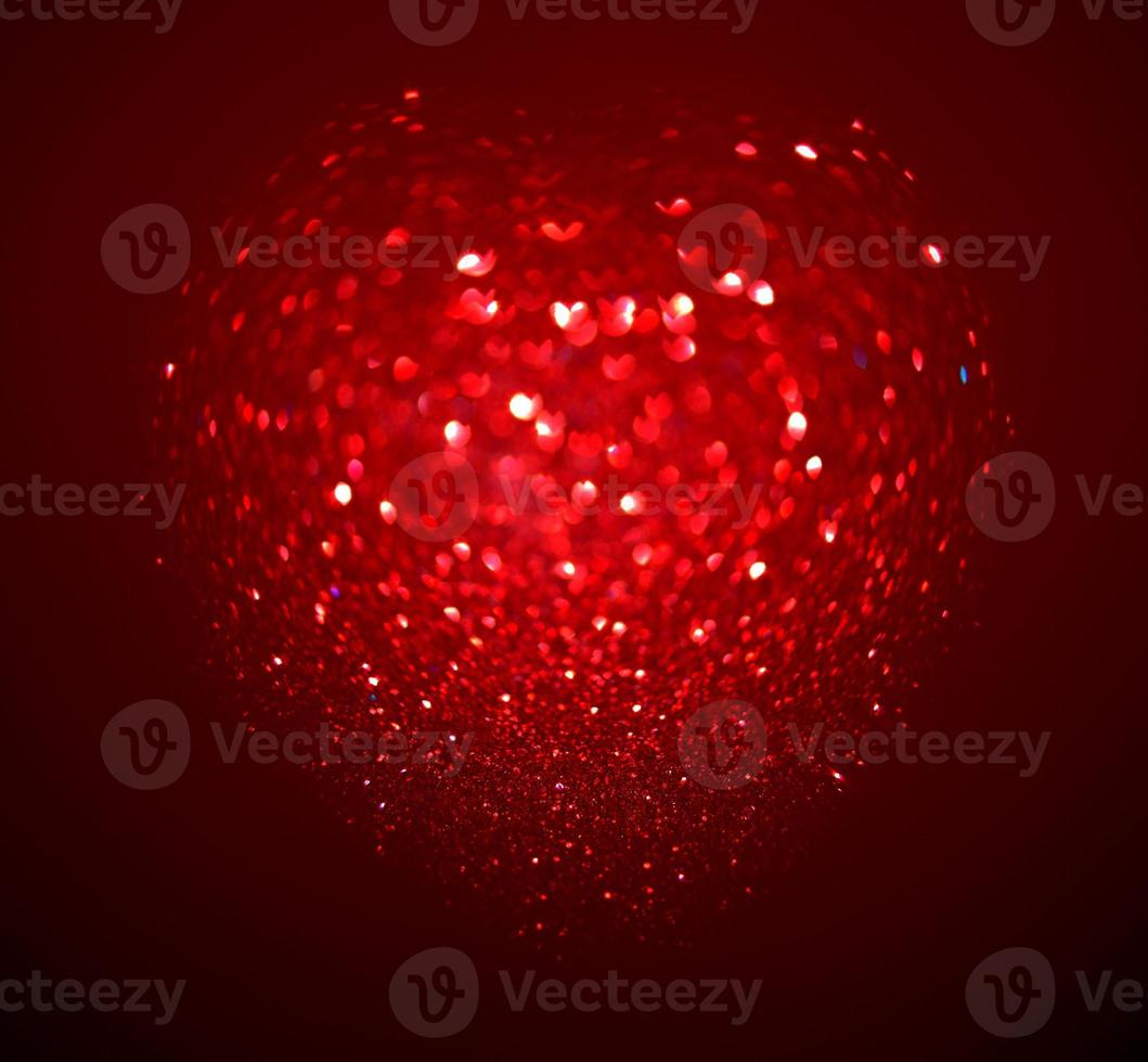 Red Blur heart shape of ligth bokeh on a black background photo