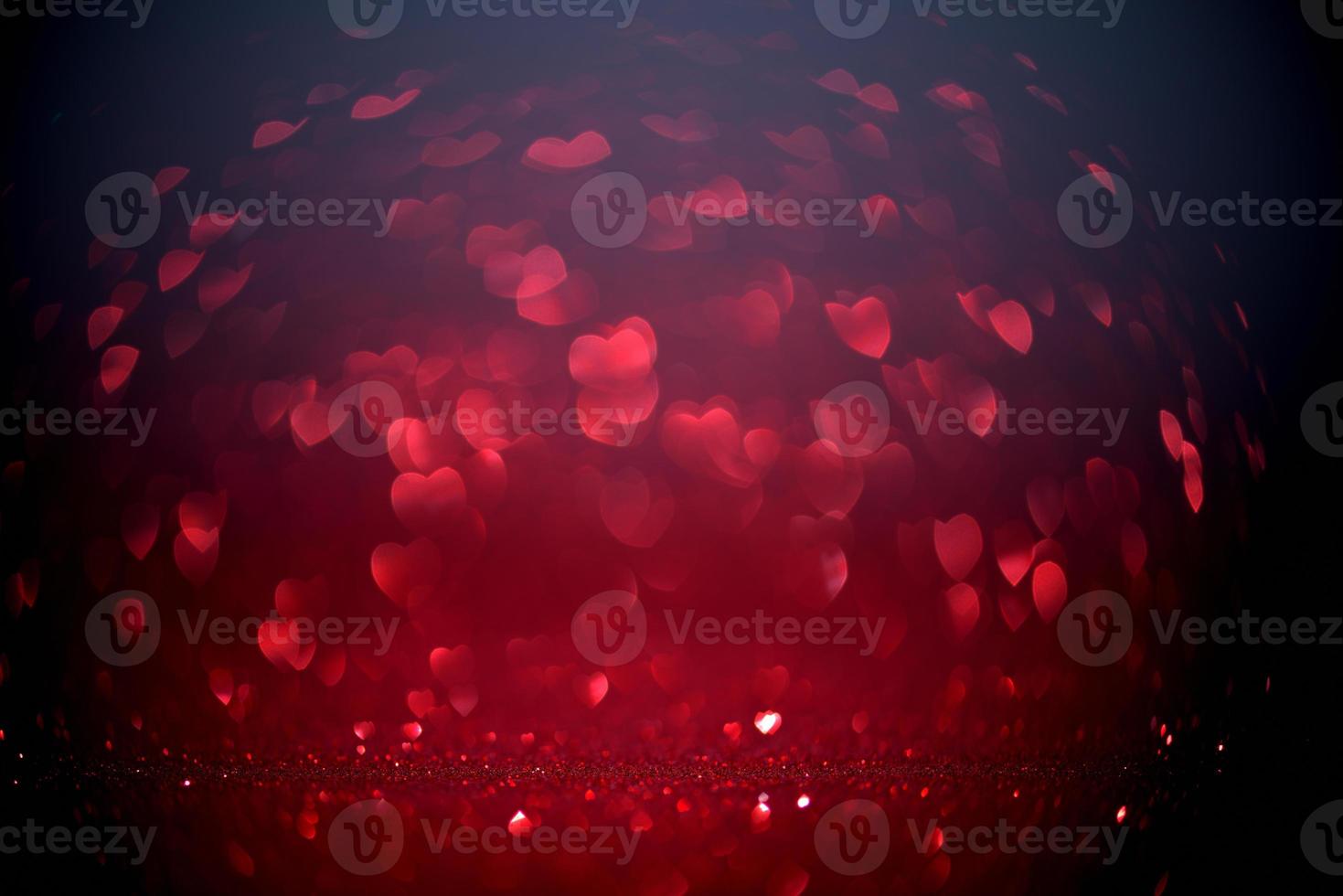 Red Blur heart shape of ligth bokeh on a black background photo