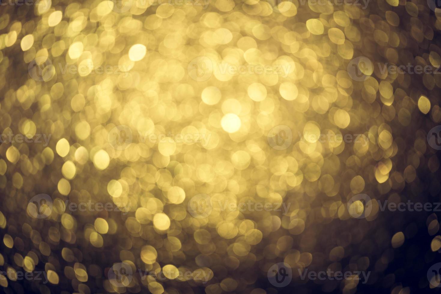 Golden glitter bokeh lighting texture Blurred abstract background for birthday, anniversary, wedding, new year eve or Christmas photo