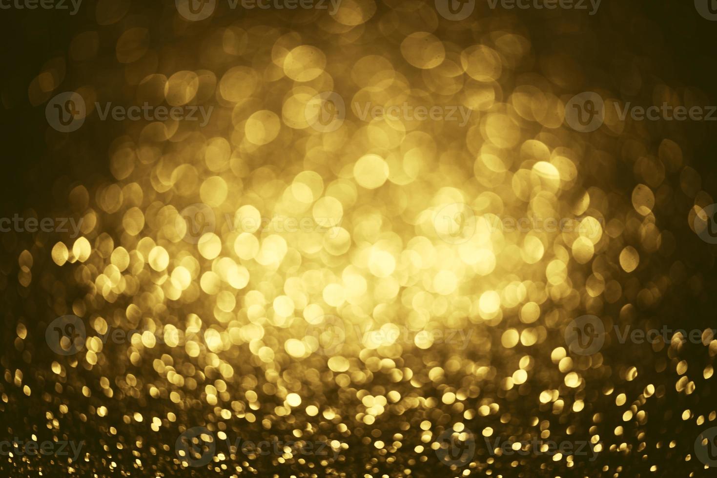 Golden glitter bokeh lighting texture Blurred abstract background for birthday, anniversary, wedding, new year eve or Christmas photo