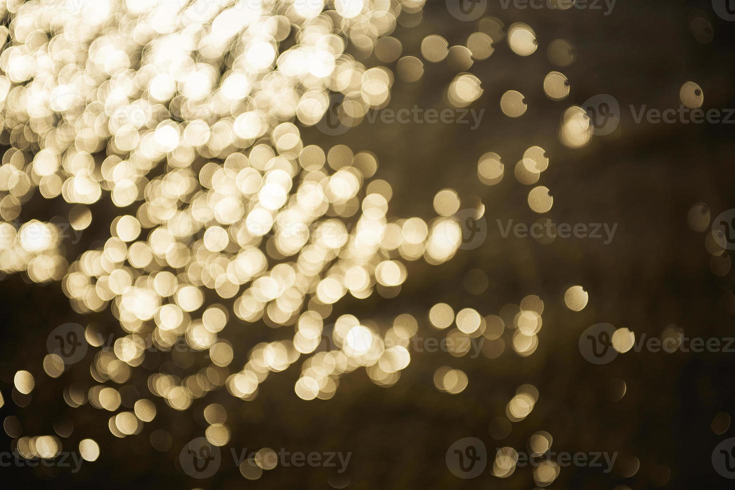 Golden glitter bokeh lighting texture Blurred abstract background for birthday, anniversary, wedding, new year eve or Christmas photo