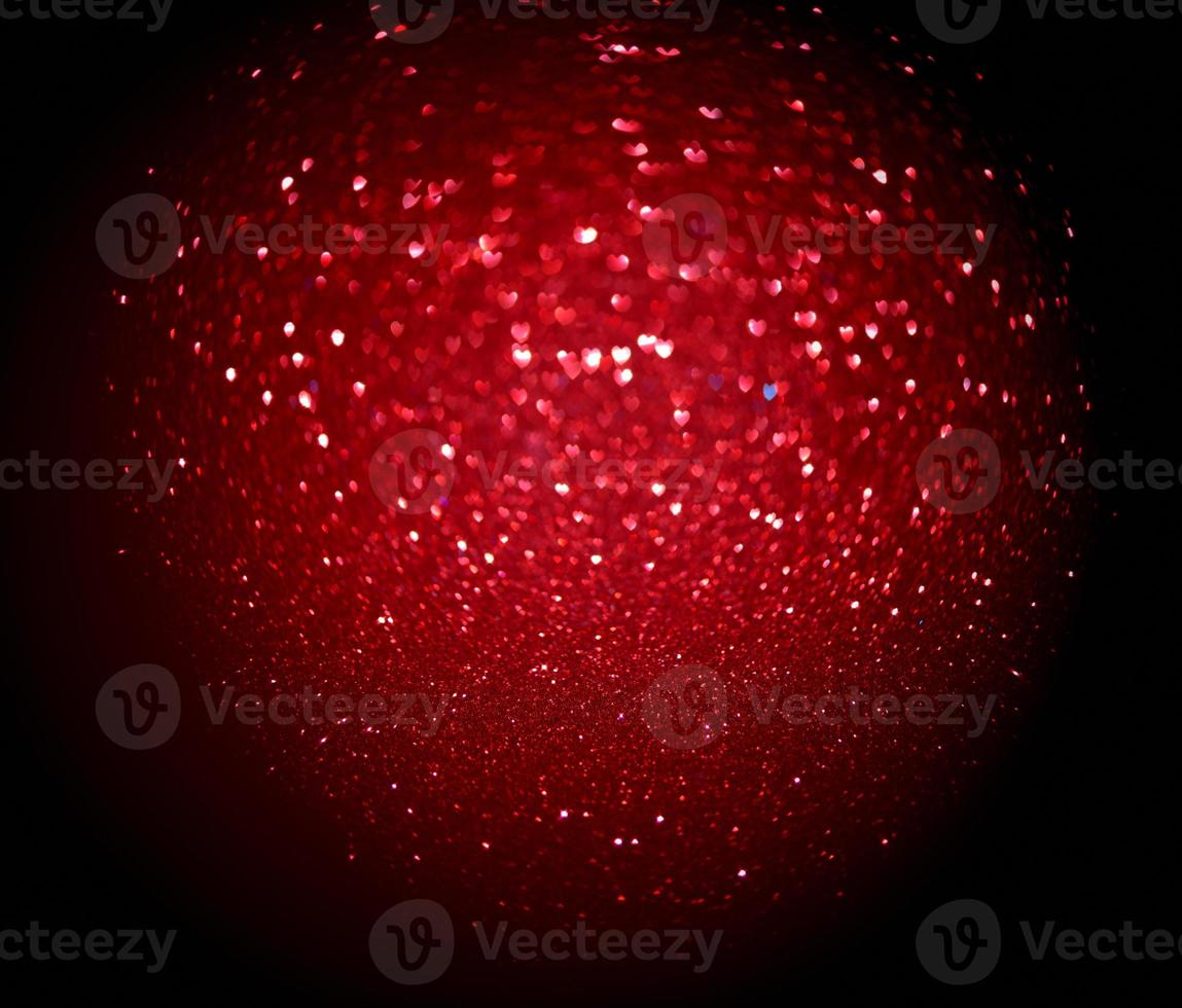 Red Blur heart shape of ligth bokeh on a black background photo