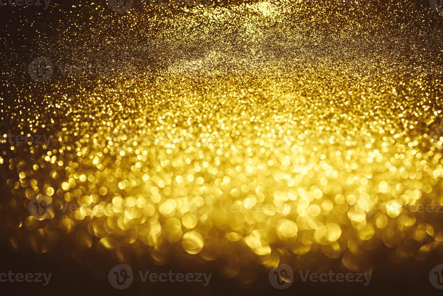 Golden glitter bokeh lighting texture Blurred abstract background for birthday, anniversary, wedding, new year eve or Christmas photo